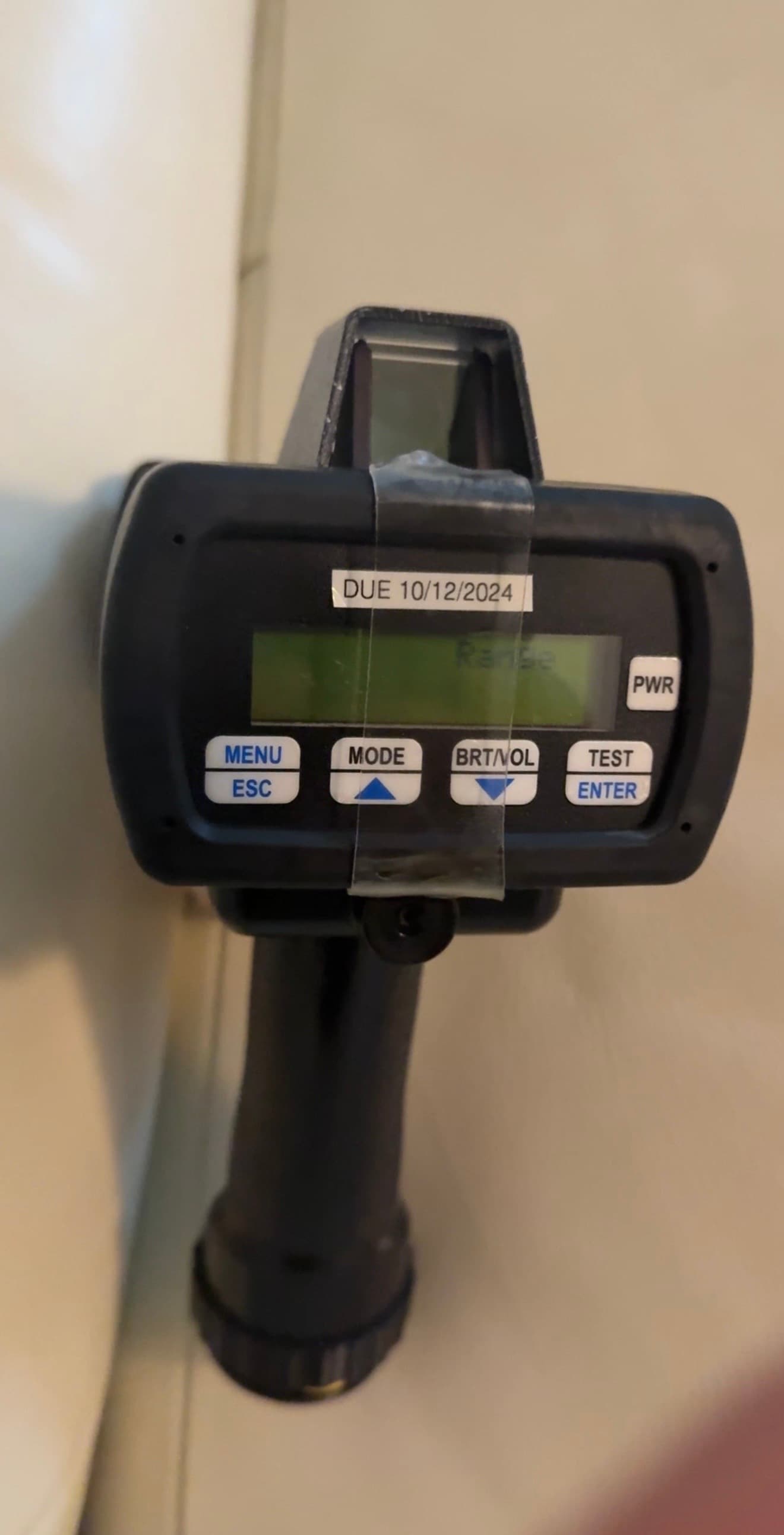 Kustom Pro Laser III handheld laser unit in range mode, calibration sticker reading DUE 10/12/2024